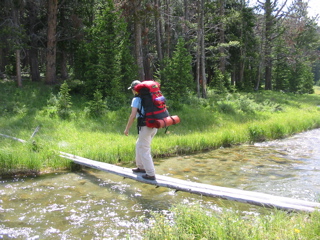 Christa crossing a creek
